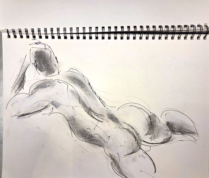 Life drawing of a reclining nude male figure, made from life in charcoal and ink.